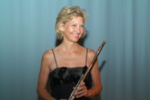 Donna half body shot with flute on long bio